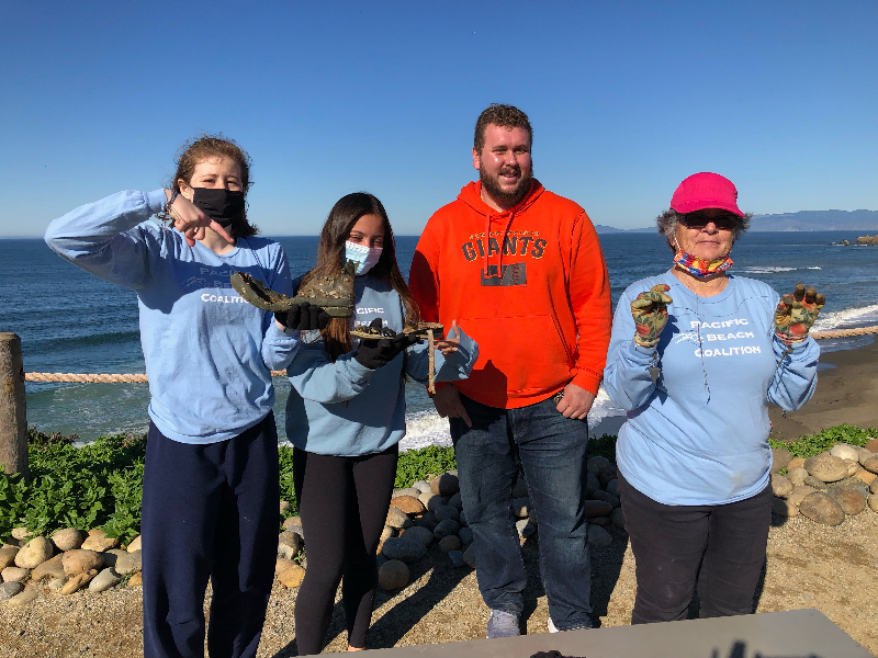 4 people at a beach clean up