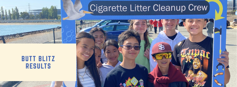 Youth volunteers holding up a large photo frame that says Cigarette Litter Cleanup Crew during 2025 Butt Blitz